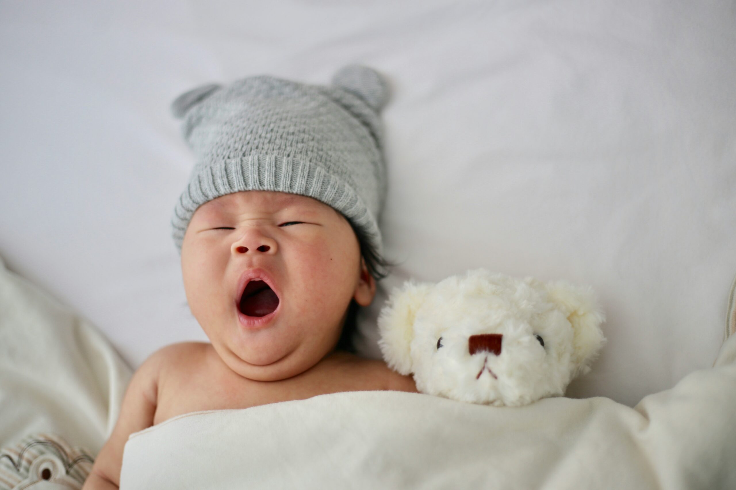 Baby is sleeping and yawning after parents learning what to do when your baby is 6 months old and not sleeping through the night