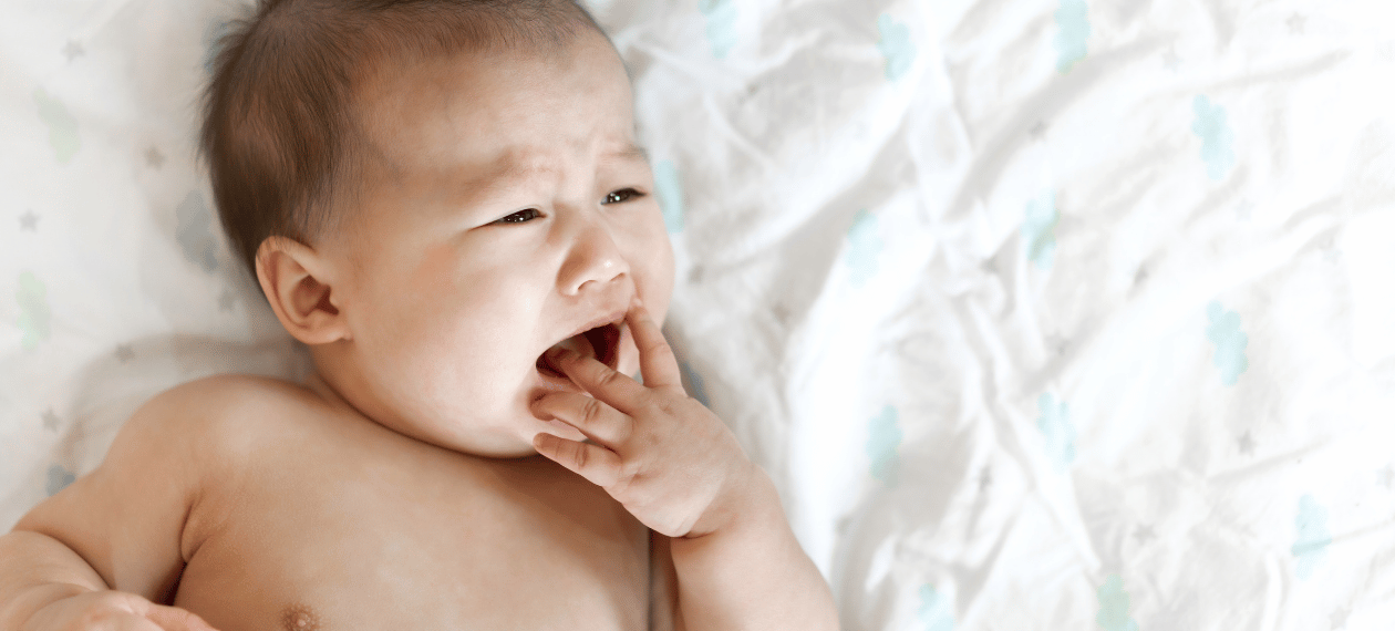 Tired baby yawning, a possible sign of overtiredness and short naps